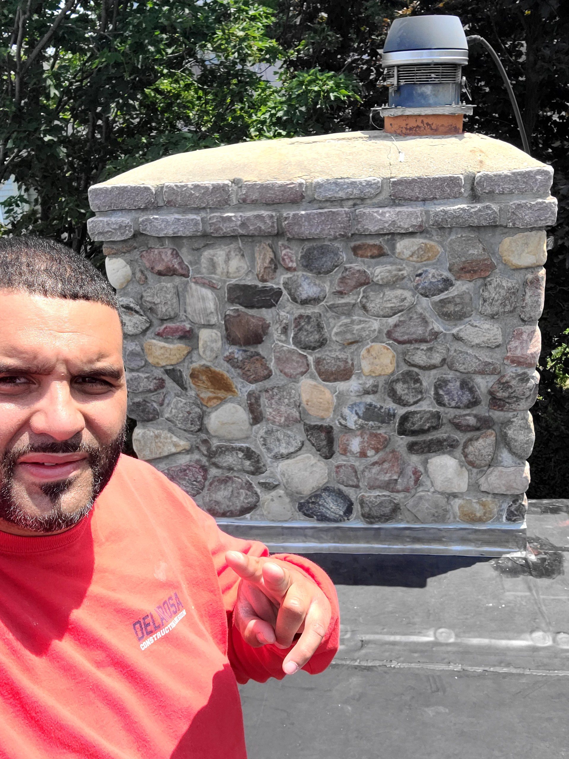 Manny De La Rosa, owner of De La Rosa Skylight & Chimney, working on a chimney